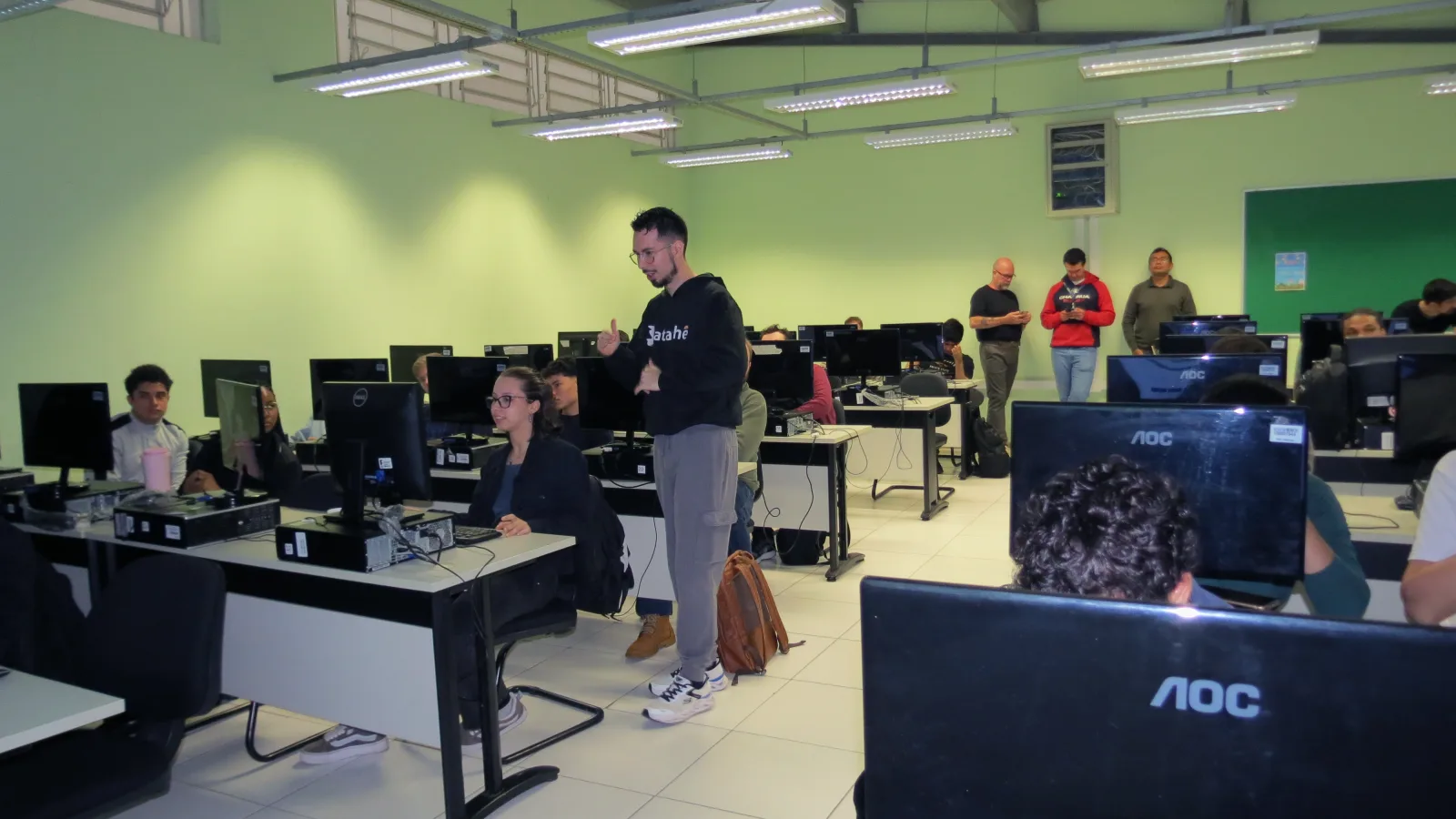 Datatchê instructor walking among students during a lab training session